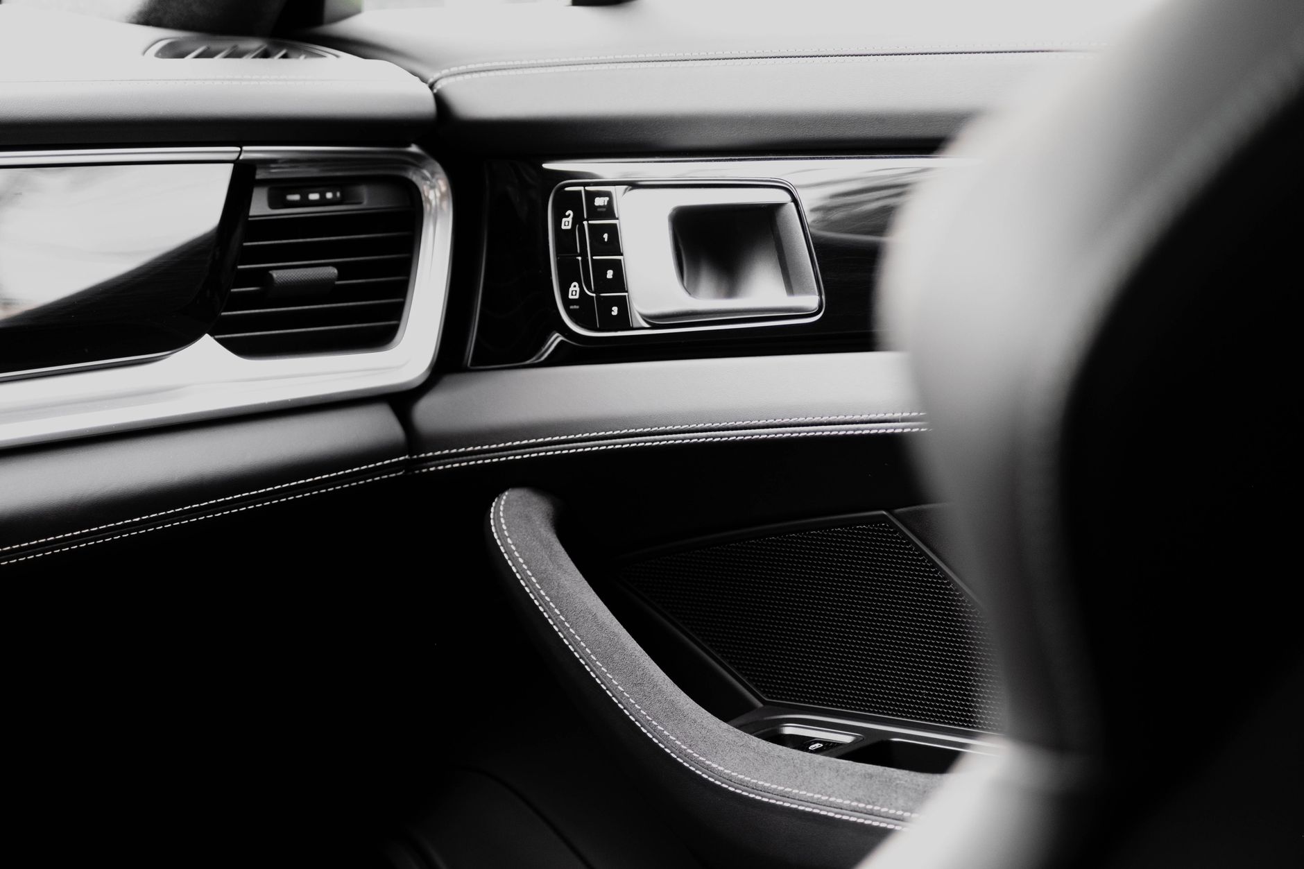 Restored monochrome interior with clean stitched leather